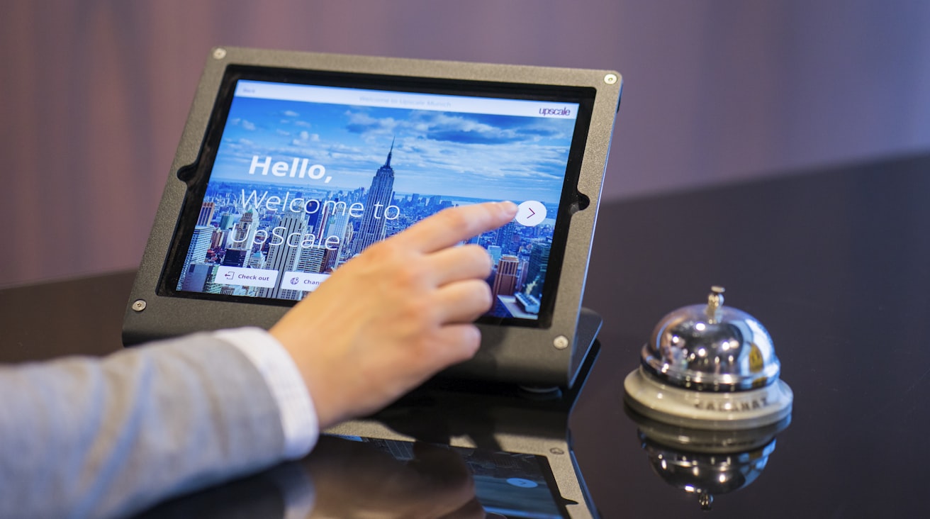 A hand updates a status on a tablet
